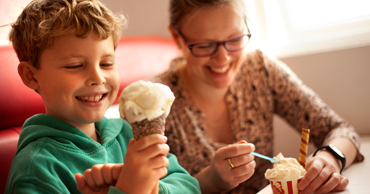 mother and son smiling whilst eating ice cream